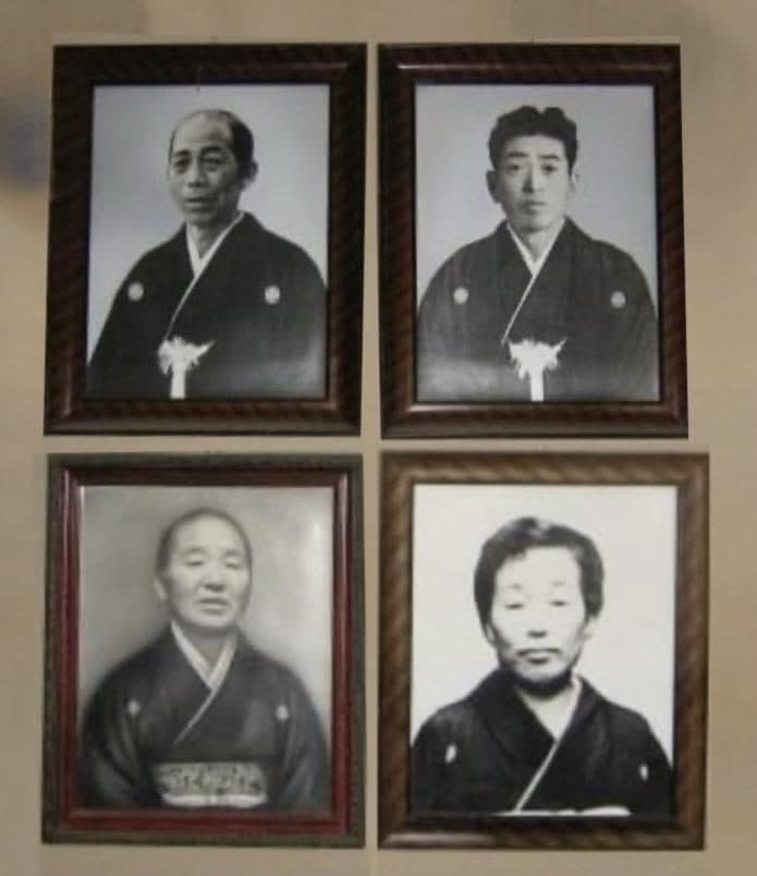 Four framed black and white ancestral portraits of people in kimono, hung in two rows on a wall.